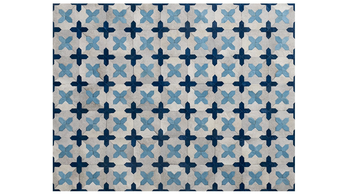 patchwork cowhide rug in off white and custom dyed dark blue and light blue colors
